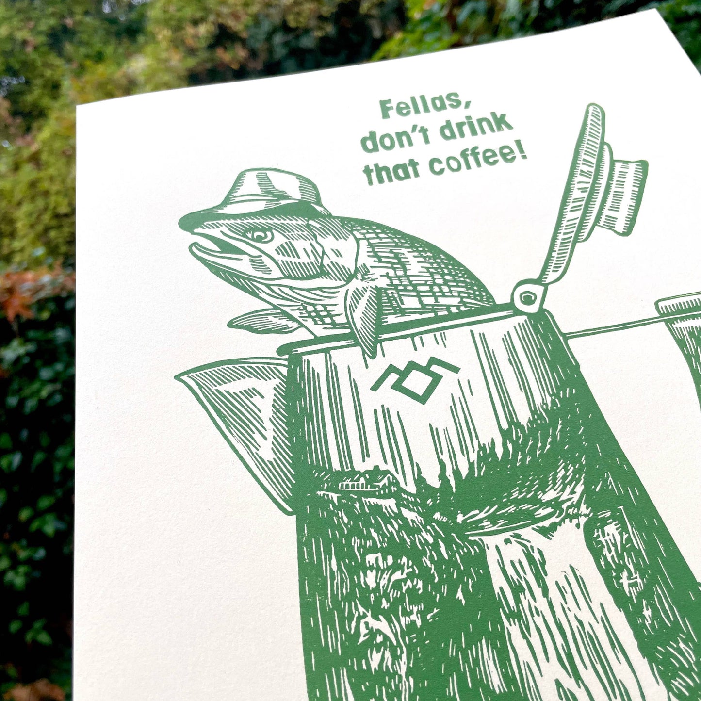 Illustration of a fish wearing a hat and in a coffee percolator that says "Fellas, don't drink that coffee!"