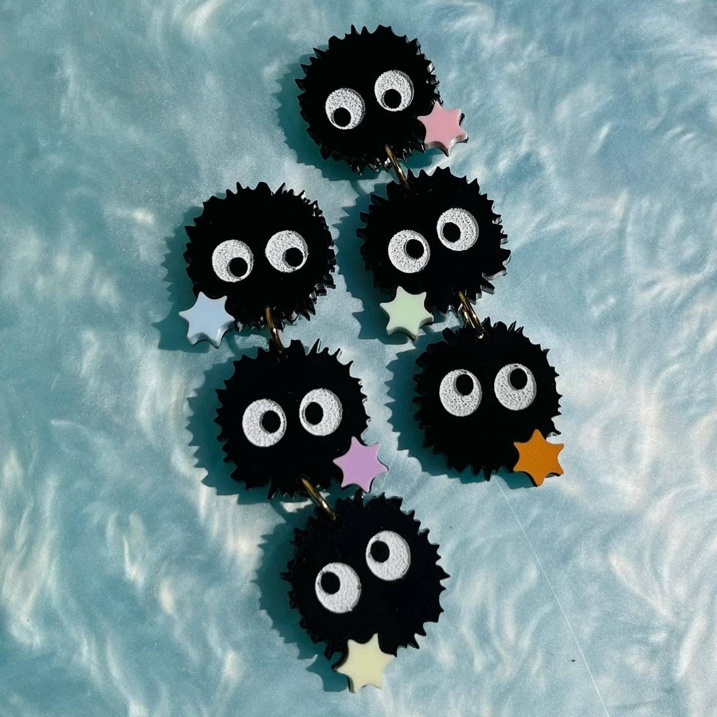 Set of three acrylic soot sprite charms with stars attached together with jump rings to make soot sprite dangling earrings. Inspired by the characters from Studio Ghibli movies