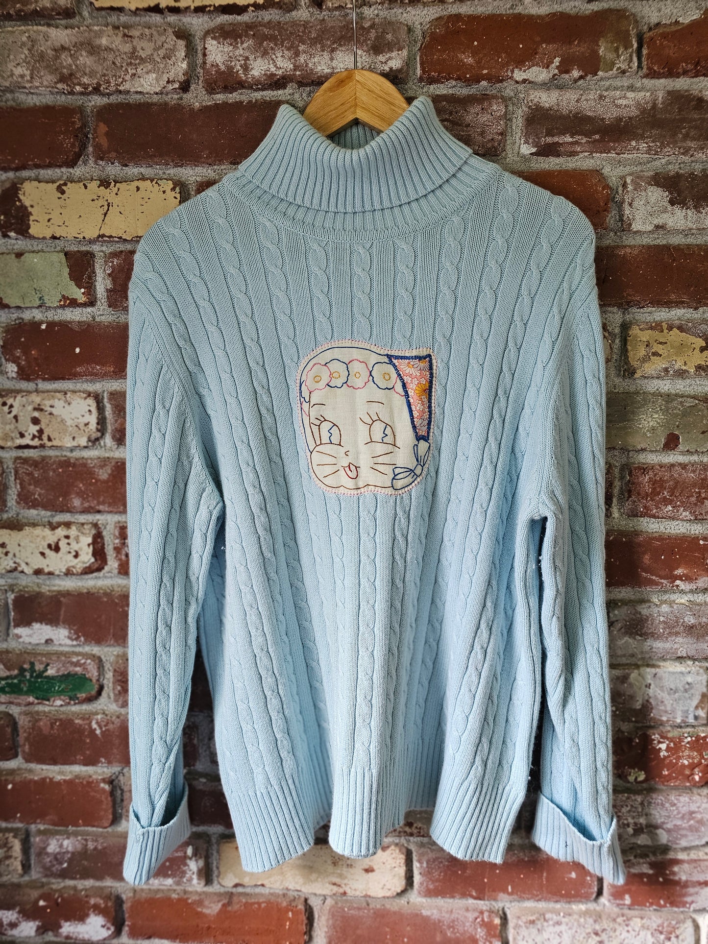 The "Fern" Upcycled Vintage Sweater - Upcycled Baby Blue Cableknit Turtleneck with Hand Embroidered Cat Patch