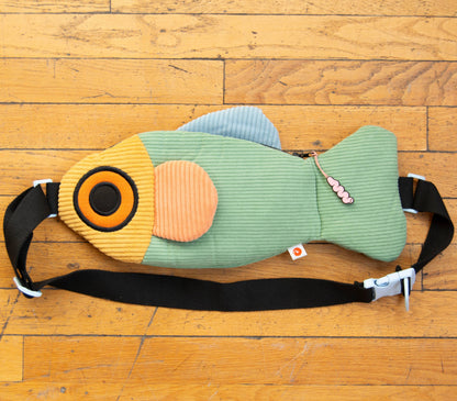 Fish-shaped bag on a wooden floor