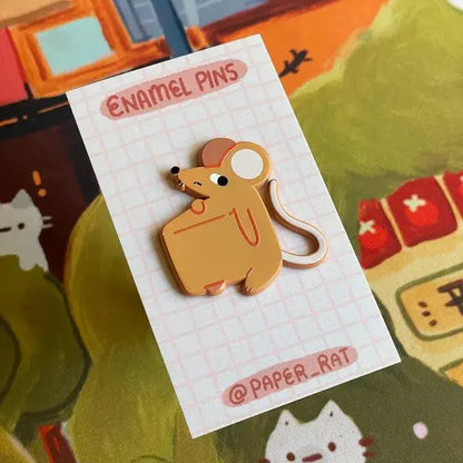 Mouse-shaped enamel pin on a branded card with a colorful background