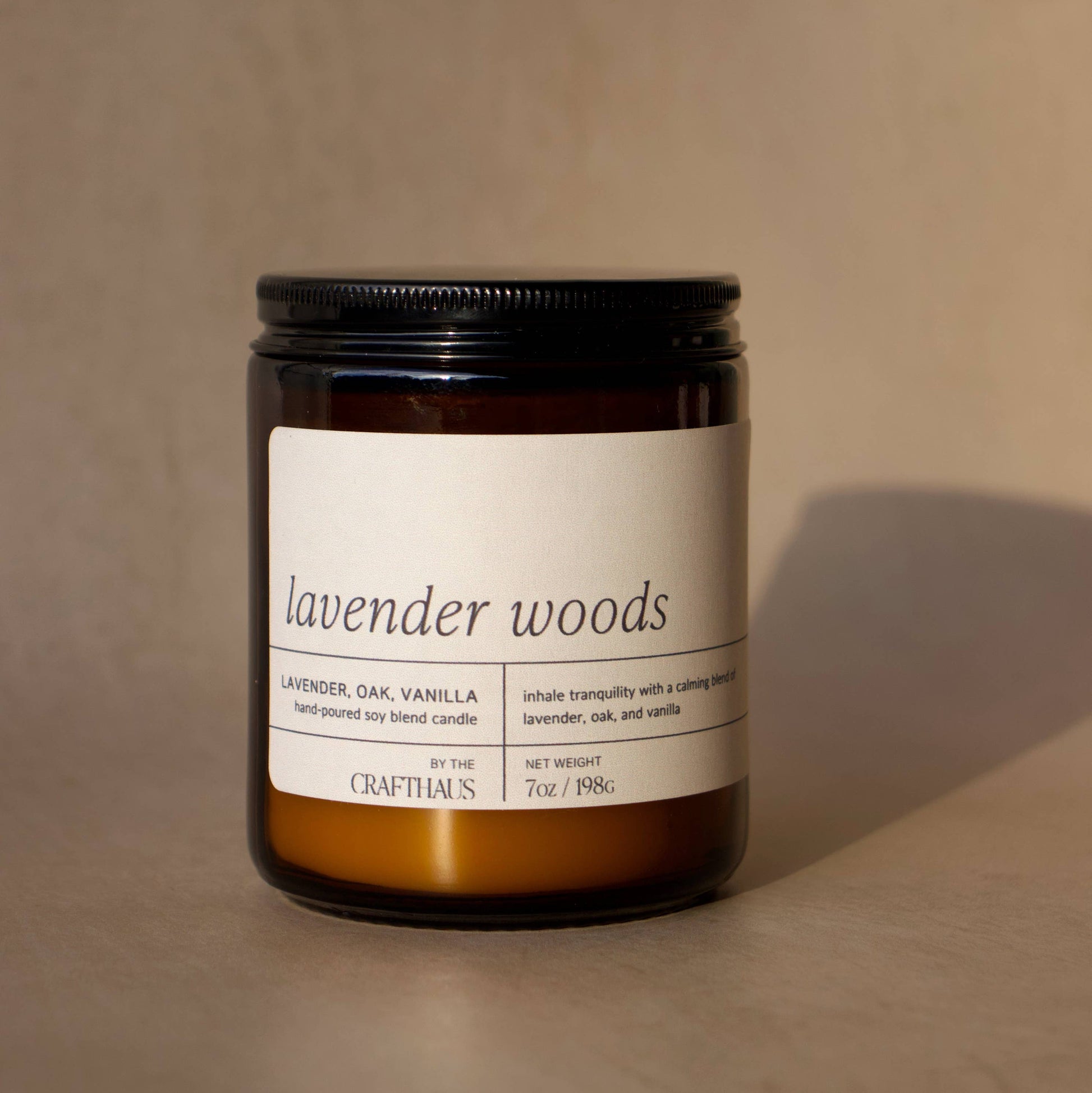 Candle labeled 'lavender woods' on a beige background