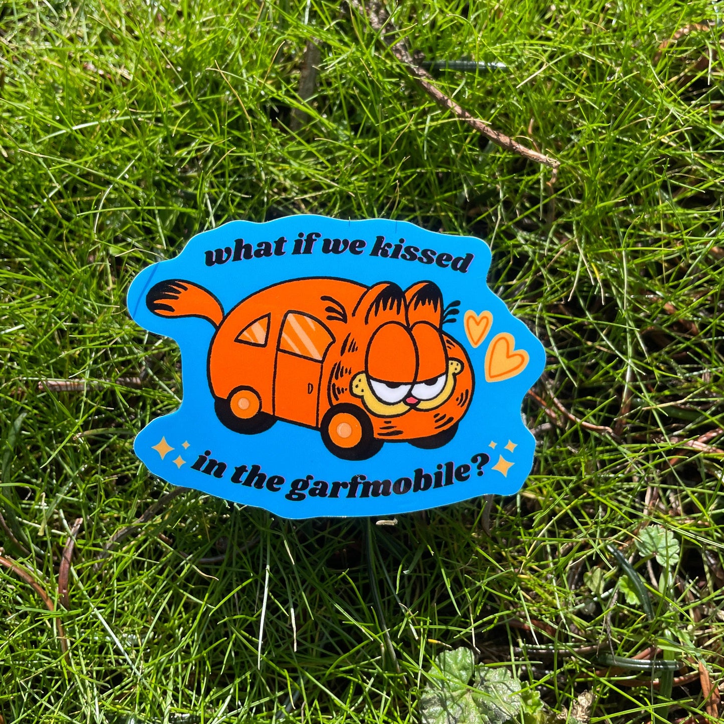 Sticker with the Garfield Mobile that reads "What if we kissed in the garfmobile?" 