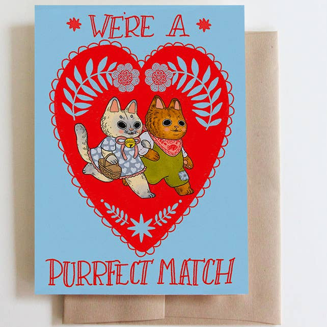 Greeting card with two cats in a heart design and 'Purrfect Match' text on a light blue background.