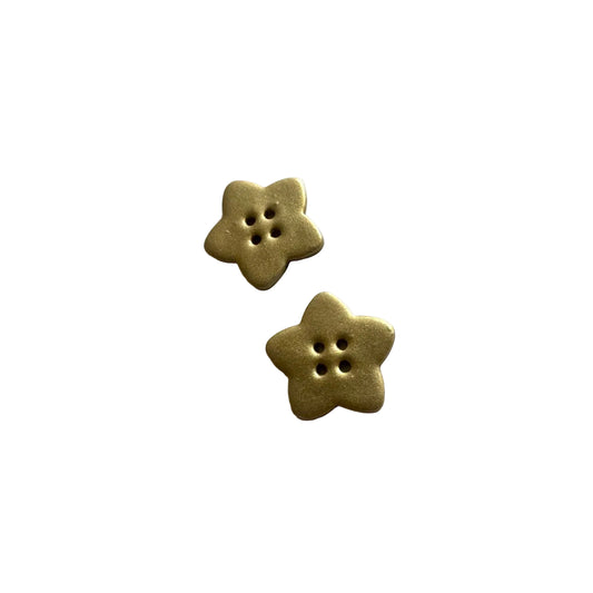 Two gold star-shaped buttons on a white background