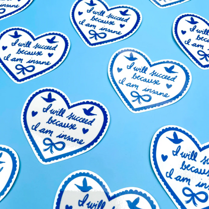 Heart-shaped stickers with motivational text on a blue background