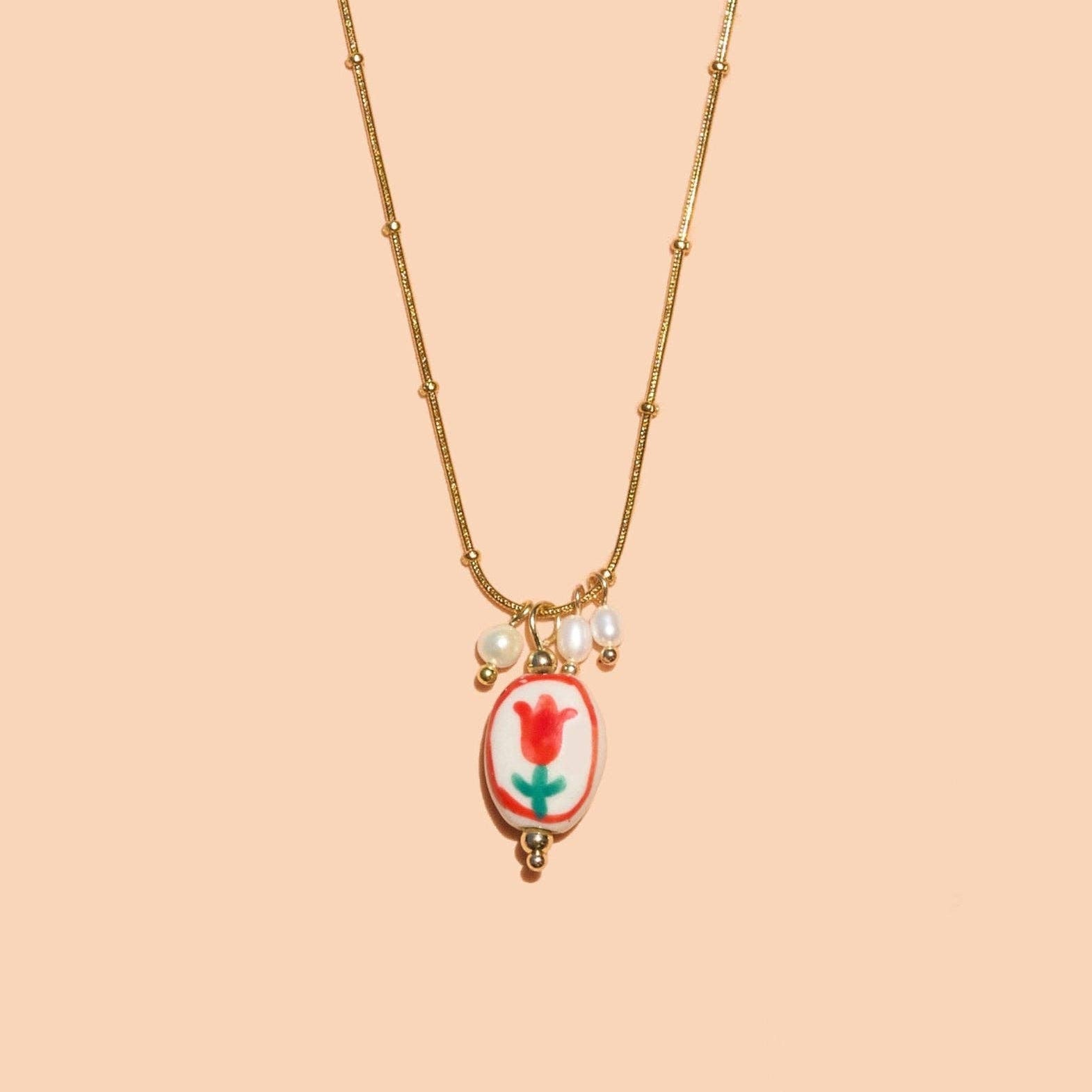 Necklace with a floral pendant on a beige background