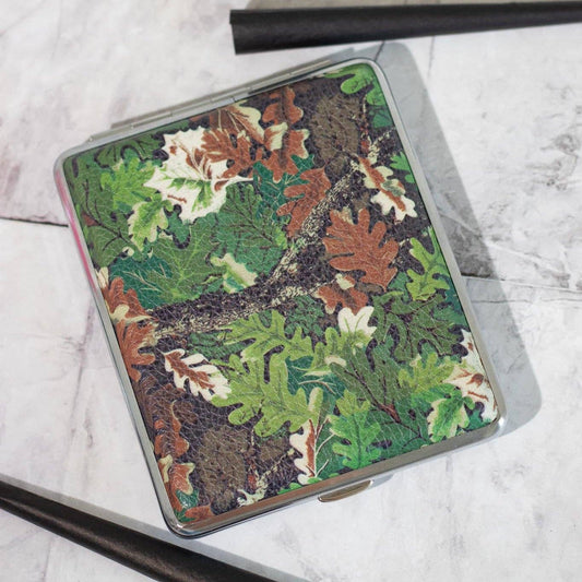 Camouflage-patterned cigarette case on a marble surface