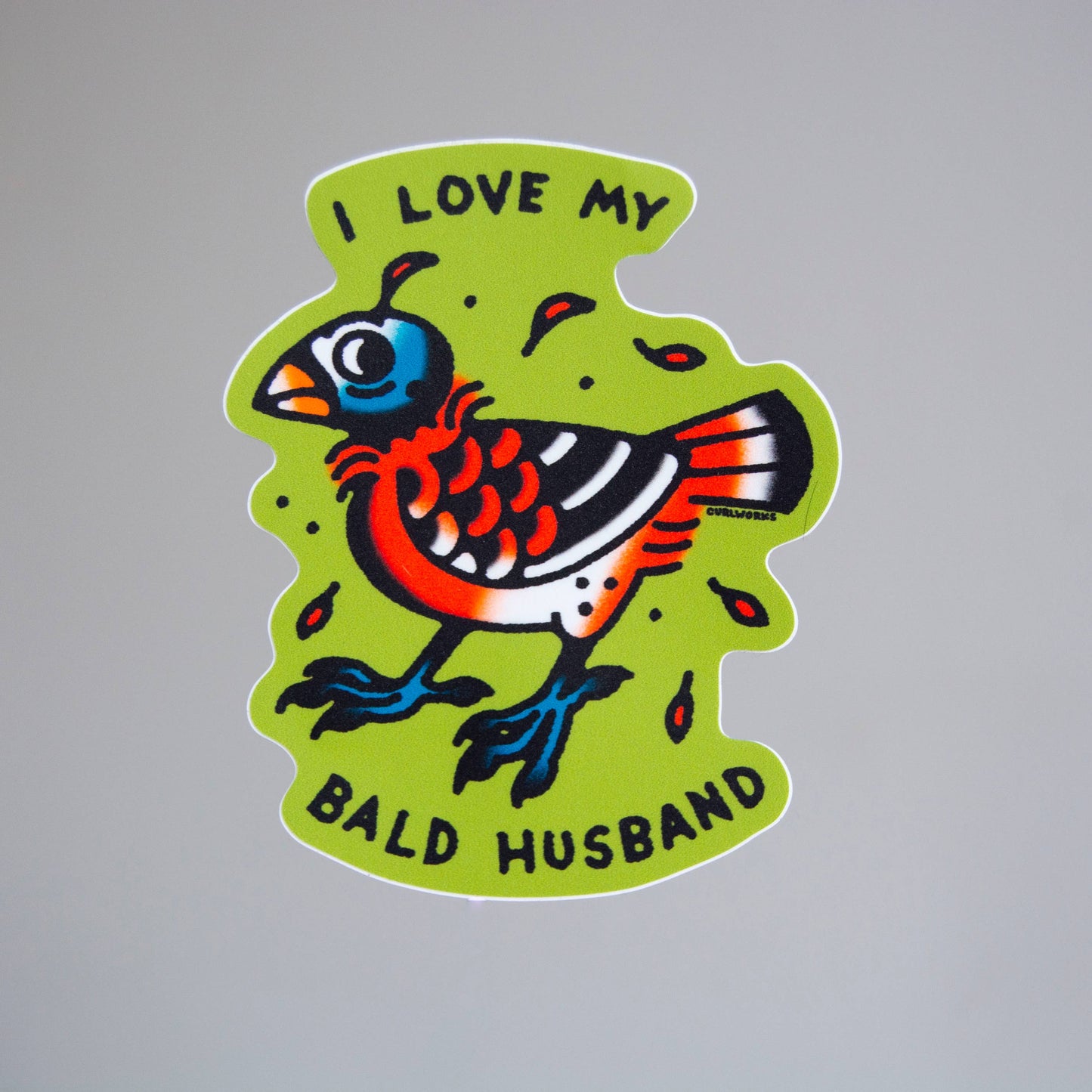 Colorful sticker with a bird design and text on a gray background